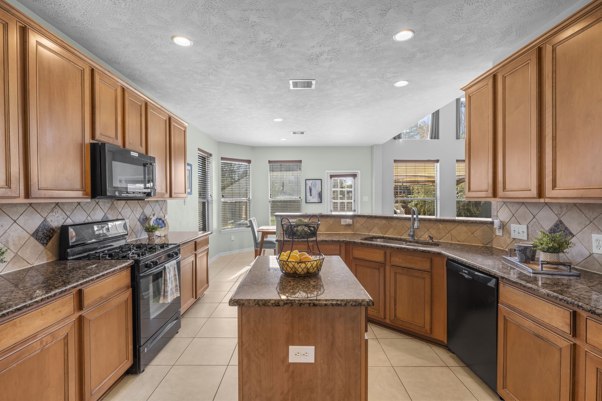 9011 Cedar Run Falls Tomball, TX 77375 - Photo 9 of 30 a kitchen with stainless steel appliances granite countertop a sink stove and cabinets