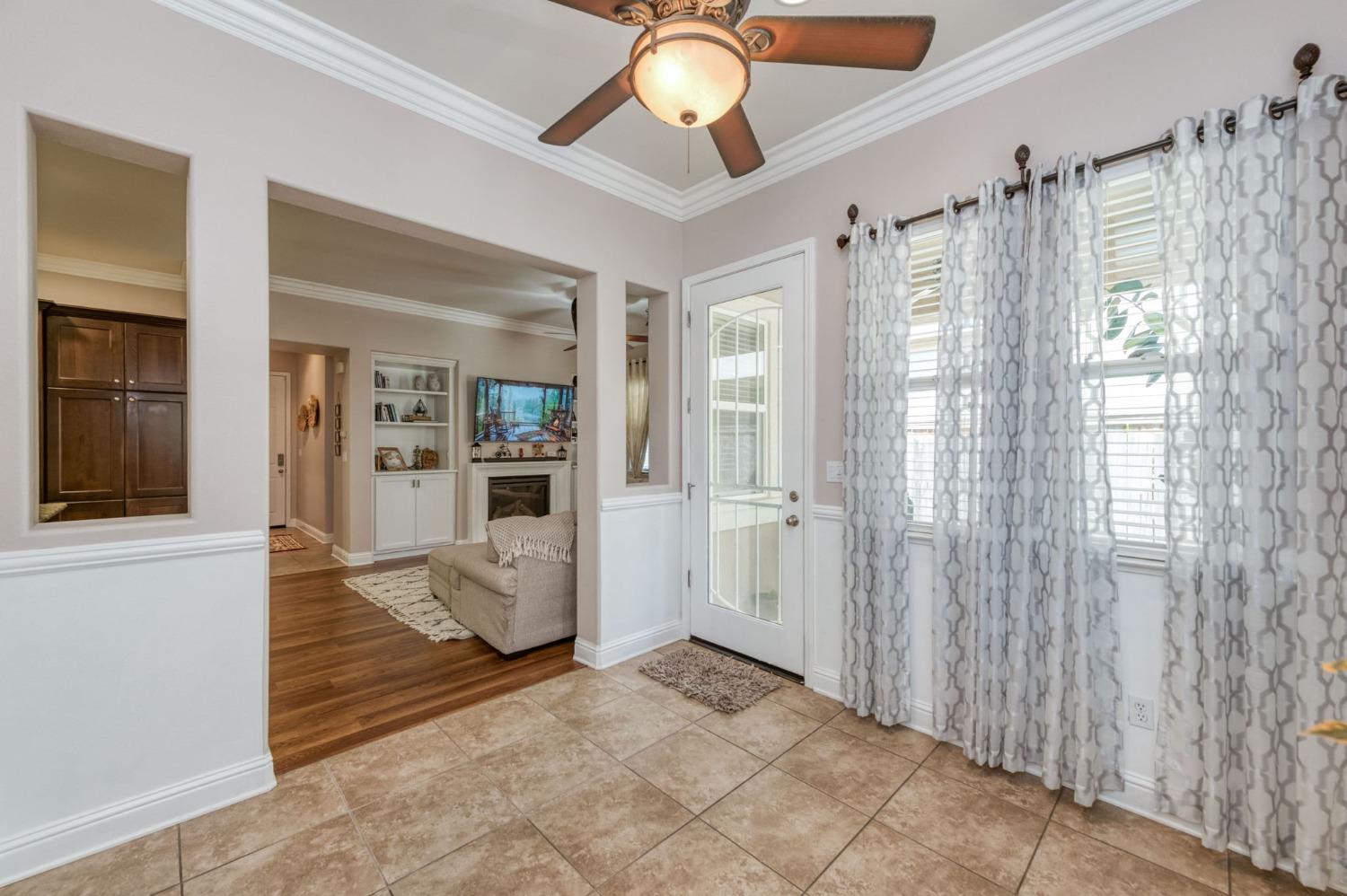 3275 Keats Avenue Clovis, CA 93619 - Photo 15 of 36 a view of a livingroom with wooden floor and a ceiling fan