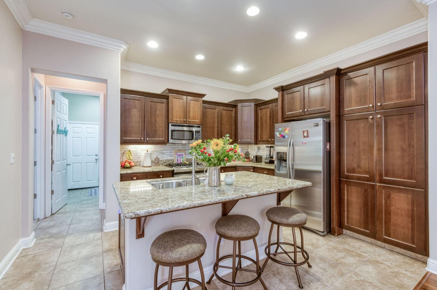 3275 Keats Avenue Clovis, CA 93619 - Photo 16 of 36 a kitchen with stainless steel appliances granite countertop a refrigerator and a sink