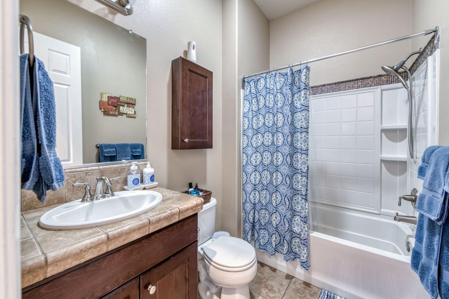 3275 Keats Avenue Clovis, CA 93619 - Photo 21 of 36 a bathroom with a granite countertop sink toilet and shower