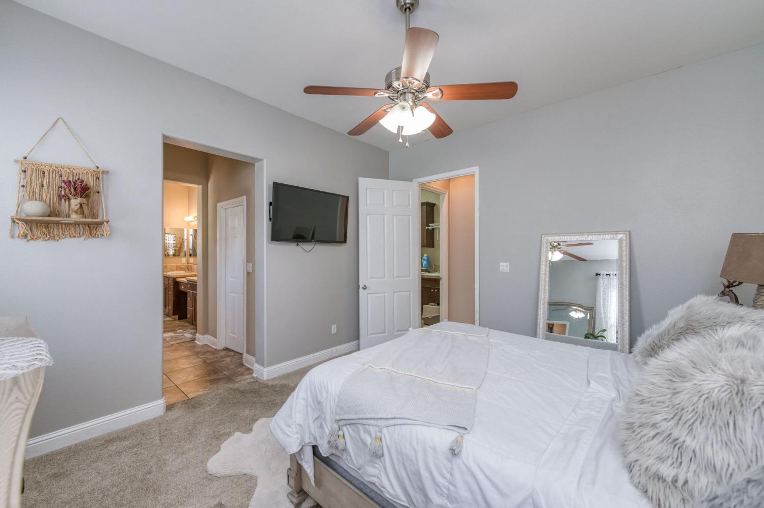 3275 Keats Avenue Clovis, CA 93619 - Photo 25 of 36 a bedroom with a bed and a chandelier