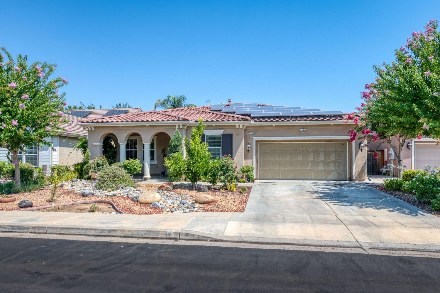 3275 Keats Avenue Clovis, CA 93619 - Photo 3 of 36 a front view of a house with a yard and potted plants