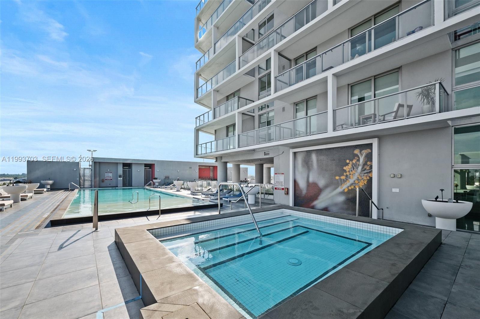 2000 Metropica Way, Unit 508 Sunrise, FL 33323 - Photo 17 of 25 a view of a patio with chairs and a barbeque