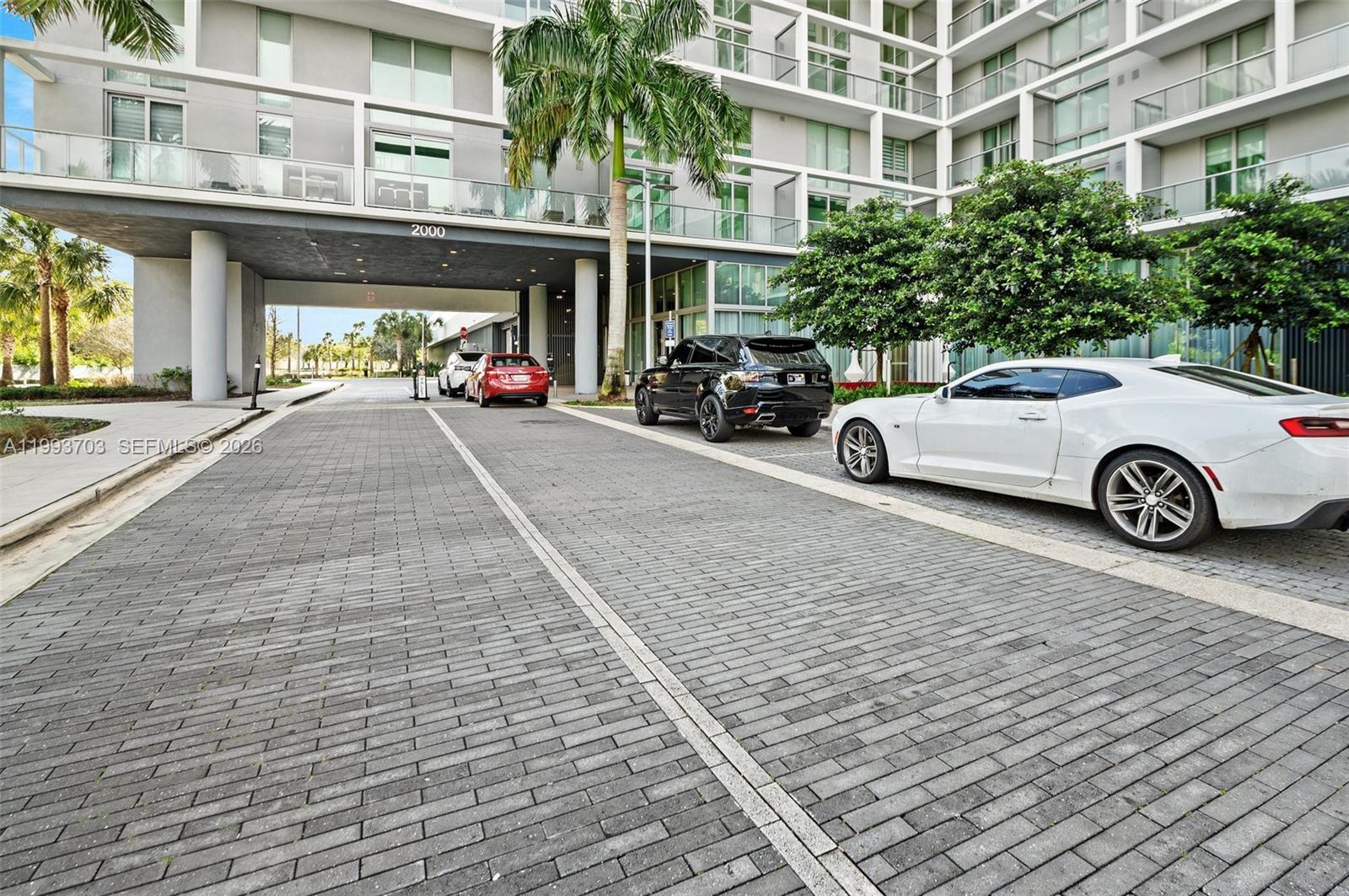 2000 Metropica Way, Unit 508 Sunrise, FL 33323 - Photo 2 of 25 a view of a car park in front of a building