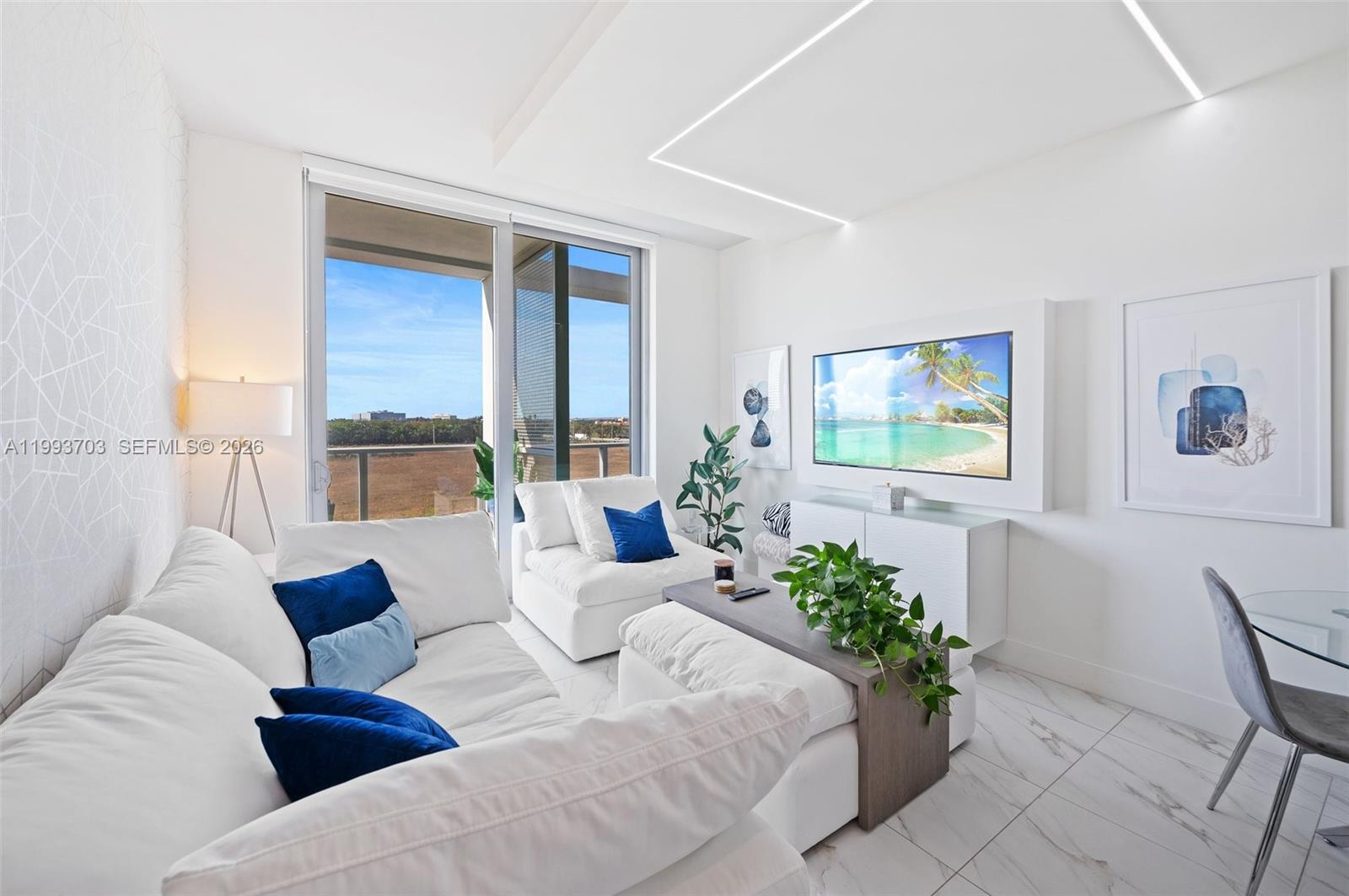 2000 Metropica Way, Unit 508 Sunrise, FL 33323 - Photo 4 of 25 a living room with furniture and a potted plant