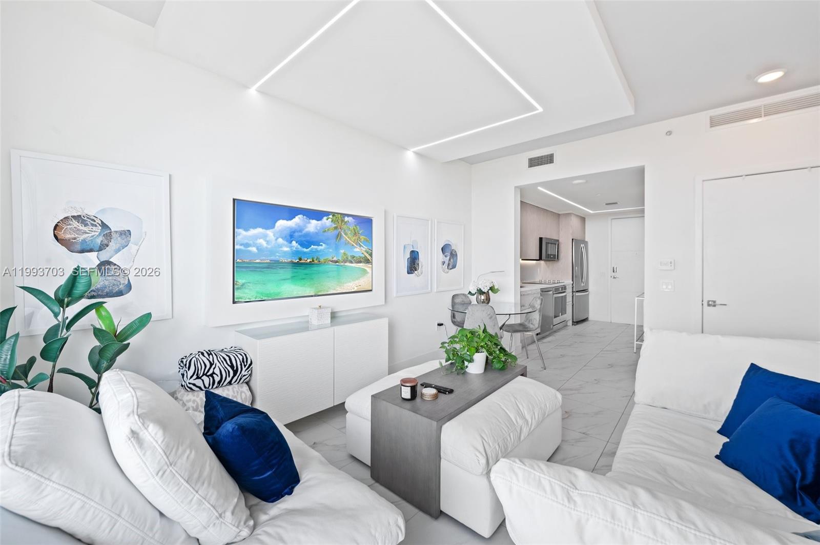 2000 Metropica Way, Unit 508 Sunrise, FL 33323 - Photo 7 of 25 a living room with furniture and a flat screen tv