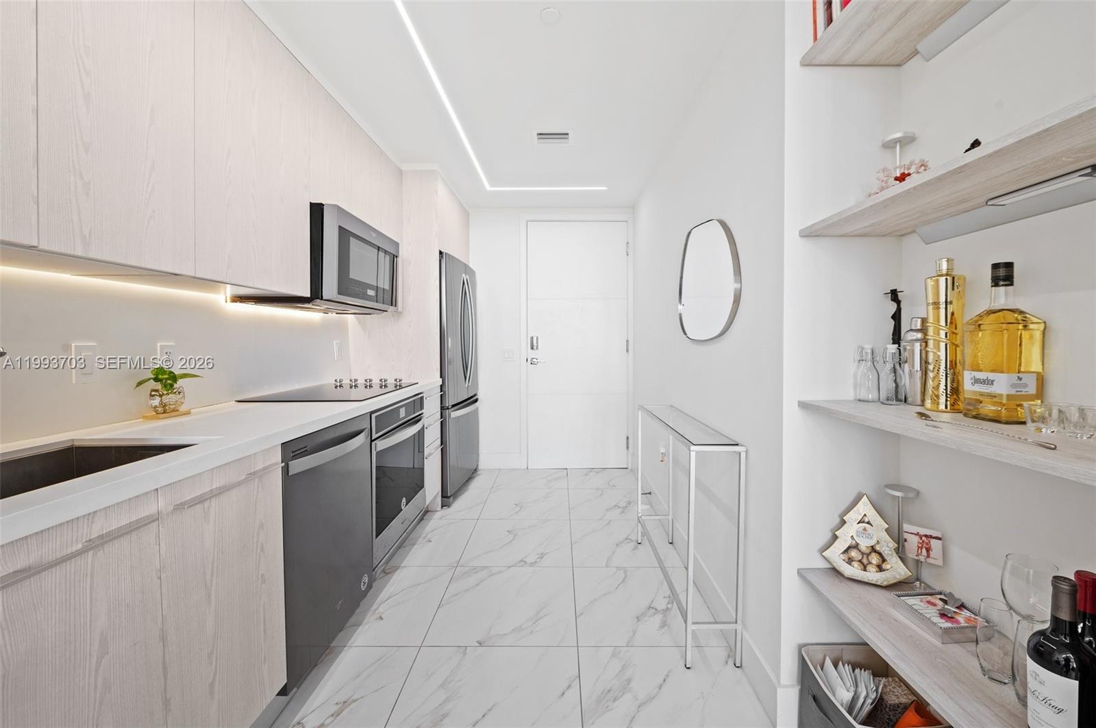 2000 Metropica Way, Unit 508 Sunrise, FL 33323 - Photo 8 of 25 a kitchen with granite countertop a sink and cabinets