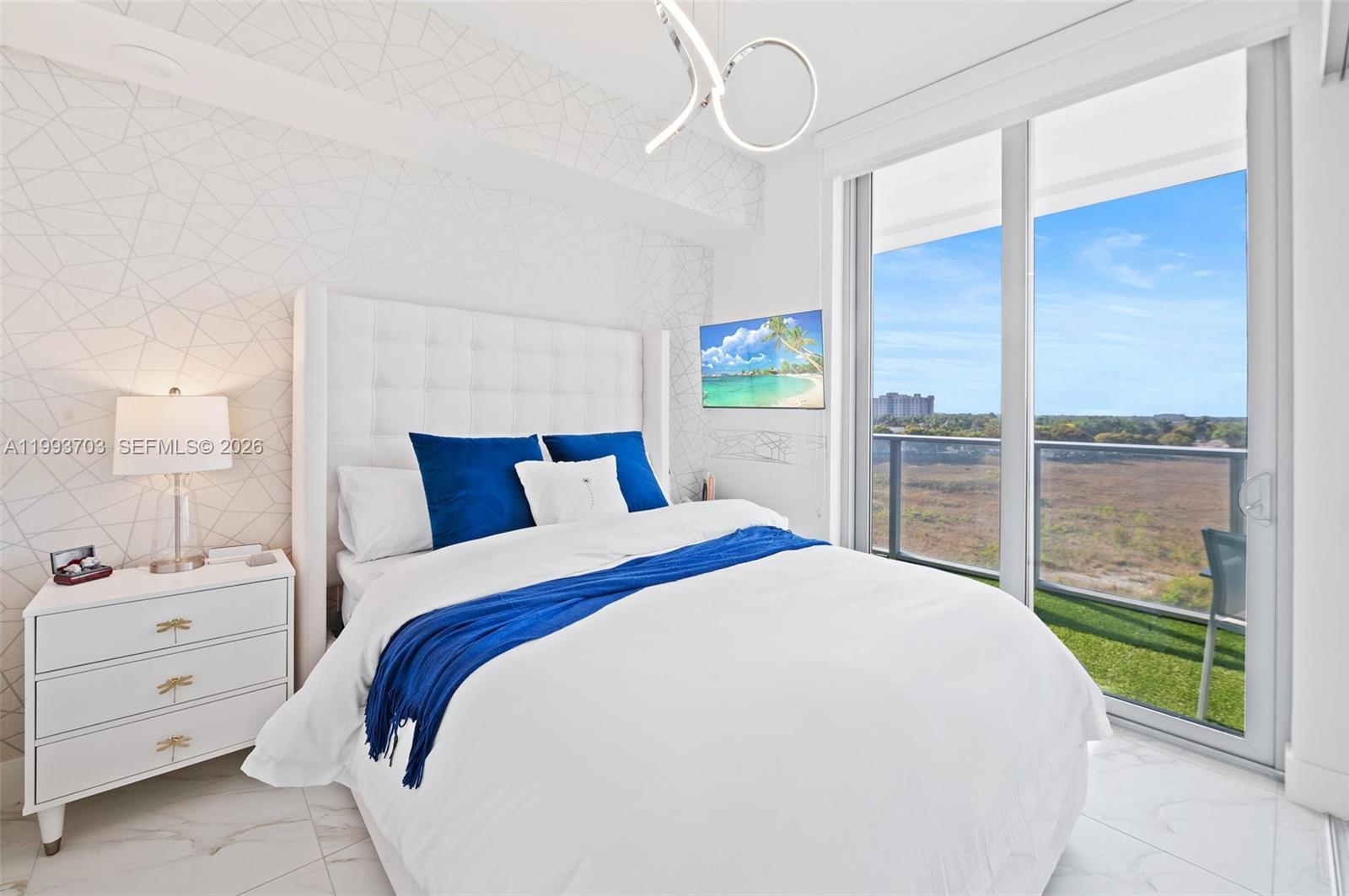 2000 Metropica Way, Unit 508 Sunrise, FL 33323 - Photo 9 of 25 a bedroom with a large bed and a window