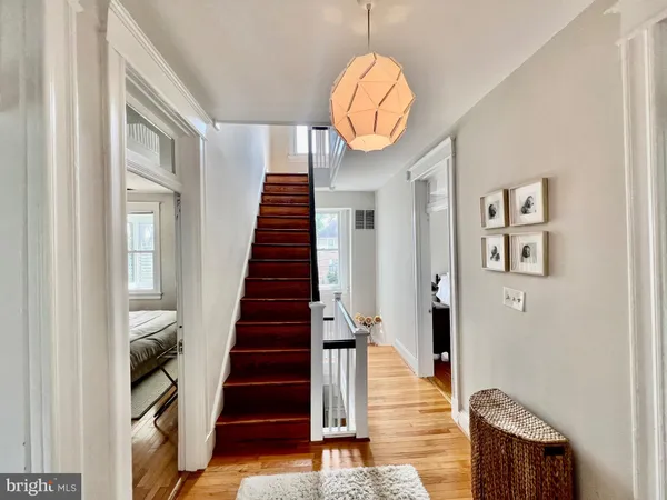 a view of entryway and hall with wooden floor
