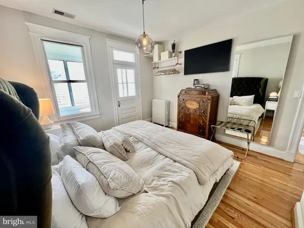 a bedroom with furniture and a flat screen tv