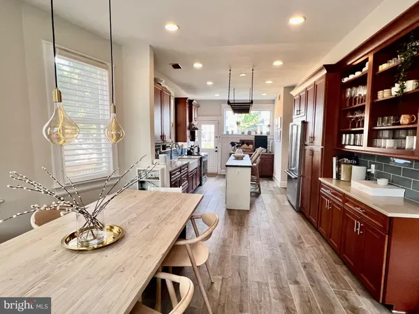 a large kitchen with a table and chairs