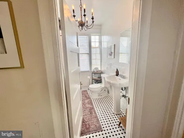 a view of a hallway with wooden floor and entryway