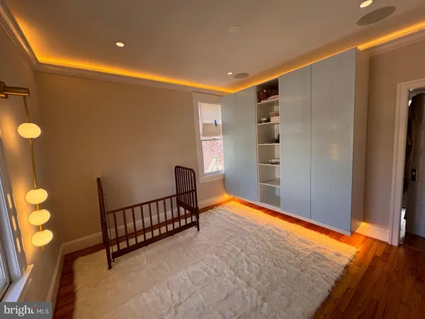 a living room with furniture and a painting on the wall