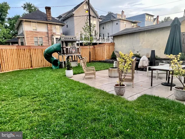 a view of a house with wooden deck and a yard