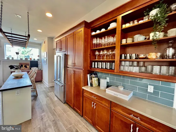 a kitchen with stainless steel appliances granite countertop a refrigerator and a stove