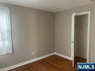 2-38 33rd Street Fair Lawn, NJ 07410 - Photo 12 of 22 a view of an empty room with wooden floor and a window
