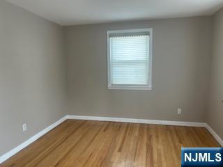 2-38 33rd Street Fair Lawn, NJ 07410 - Photo 13 of 22 a view of an empty room with wooden floor and a window