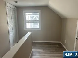 a view of room with window and hardwood floor