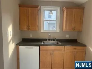 a bathroom with a granite countertop sink and a cabinets