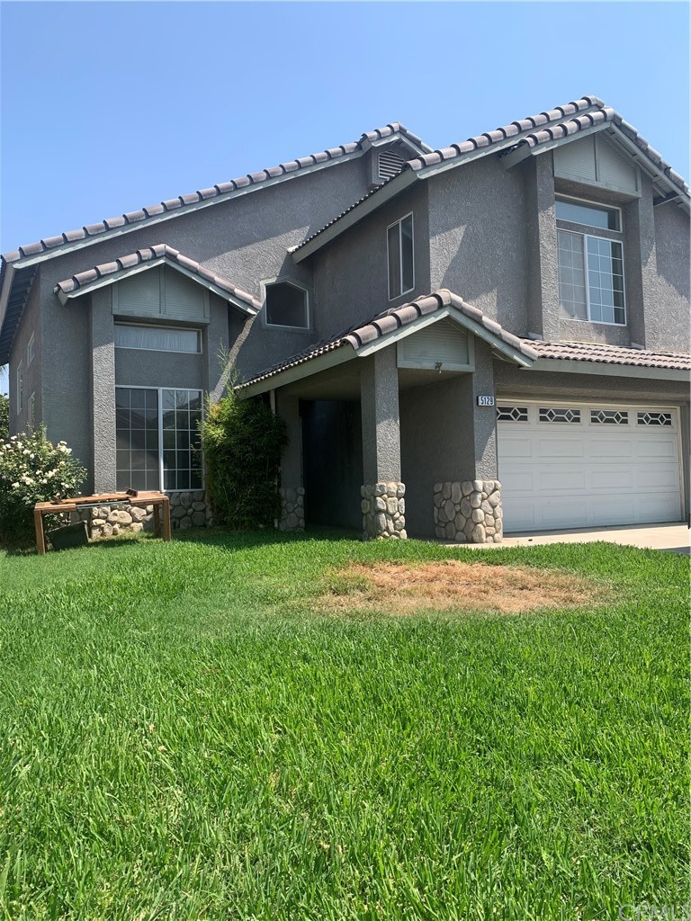 5129 Sierra Cross Way Riverside, CA 92509 - Photo 1 of 1 a front view of a house with a yard and garage