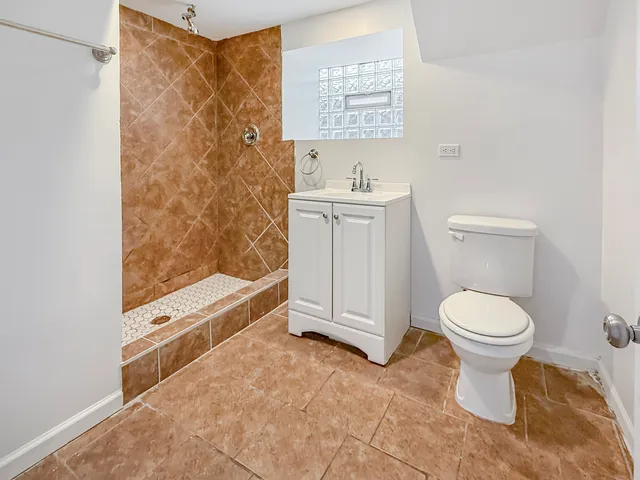 a bathroom with a toilet sink and shower