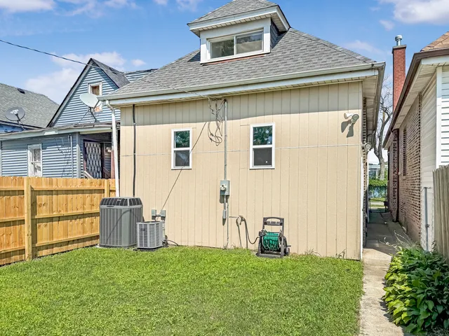 a view of a house with a yard and sitting area
