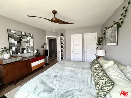 a bed room with a bed and a large mirror