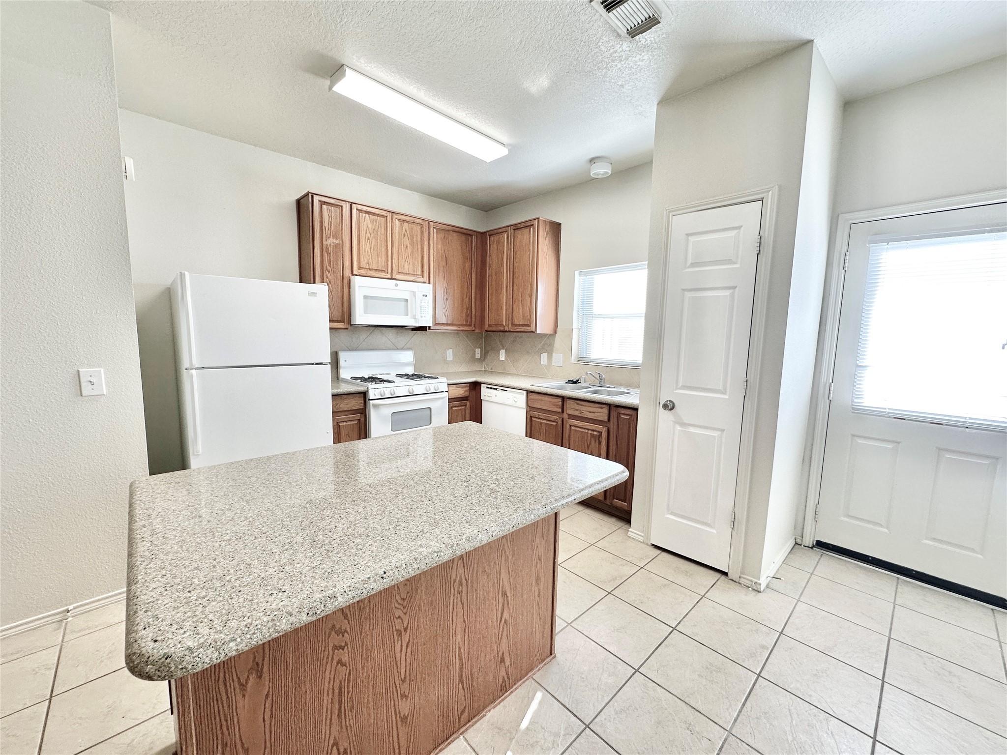 29709 Valley Center Drive Spring, TX 77386 - Photo 10 of 15 a kitchen with stainless steel appliances granite countertop a refrigerator sink stove and microwave