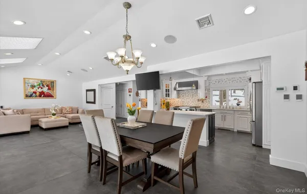 a view of a dining room with furniture and chandelier