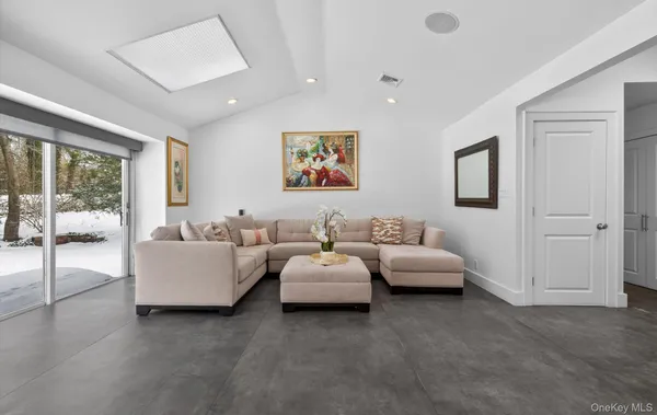 a living room with furniture and large windows
