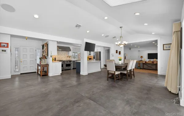 a living room with furniture and kitchen view