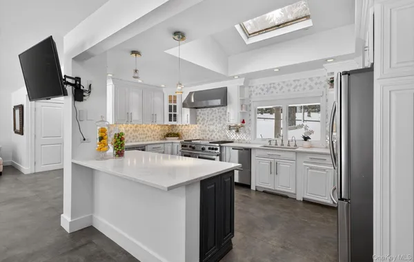 a kitchen with sink cabinets and stainless steel appliances