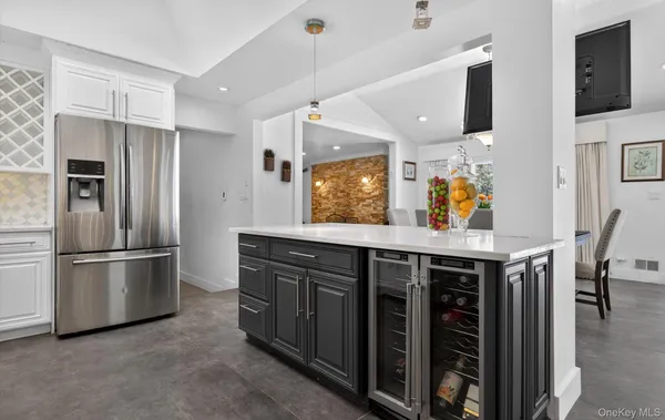 a kitchen with stainless steel appliances a stove a refrigerator and wooden cabinets