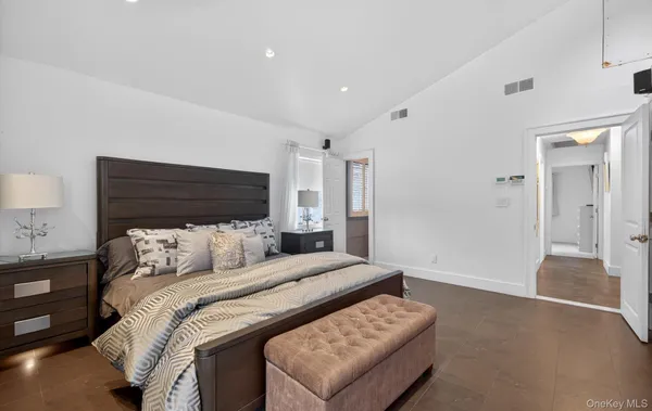 a bedroom with a bed and a lamp