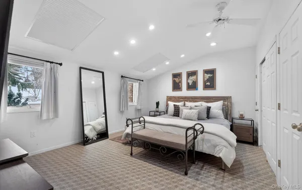 a spacious bedroom with a bed and a large mirror