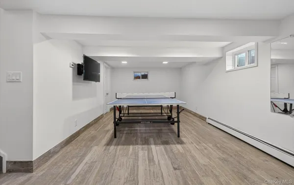 a bedroom with wooden floor and a ceiling fan