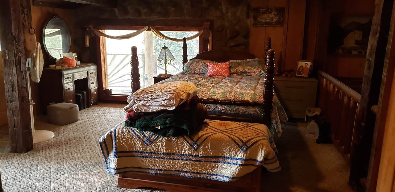 110 Forest Service Road Englewood, TN 37329 - Photo 3 of 33 a bed sitting in a bedroom next to a window