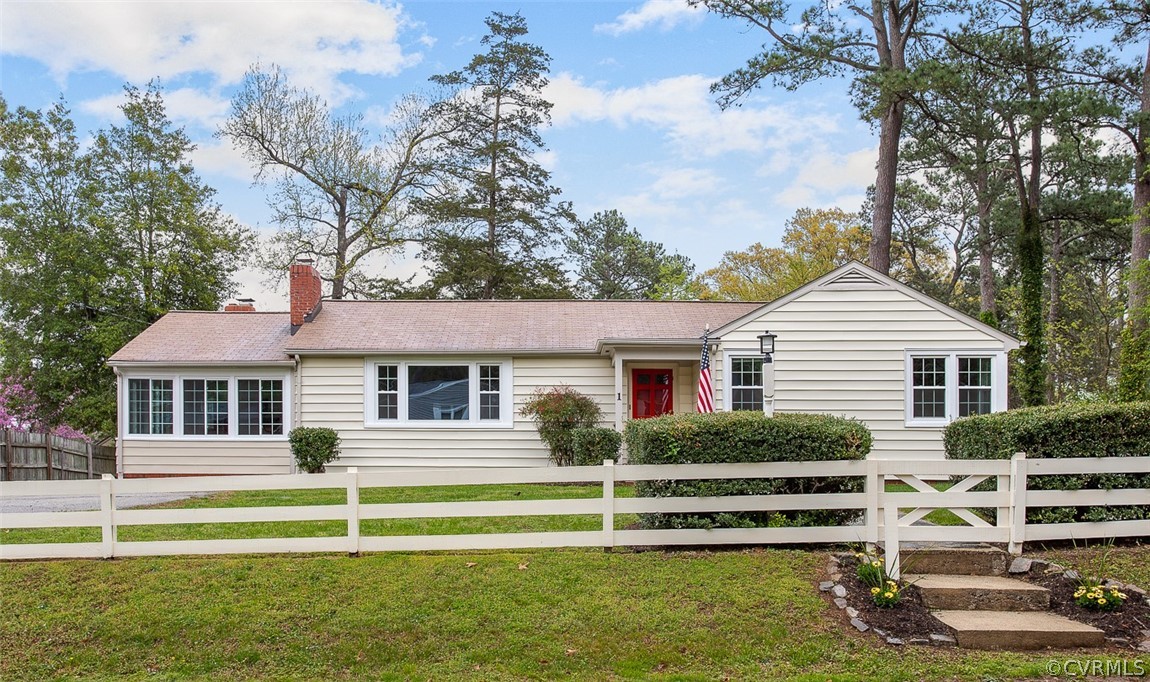 a front view of a house with a garden and swimming pool