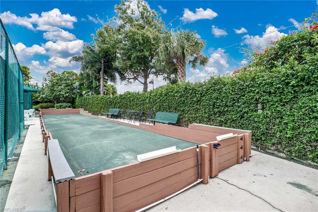 716 Reef Point Circle Naples, FL 34108 - Photo 12 of 15 a view of a backyard with brick wall and plants