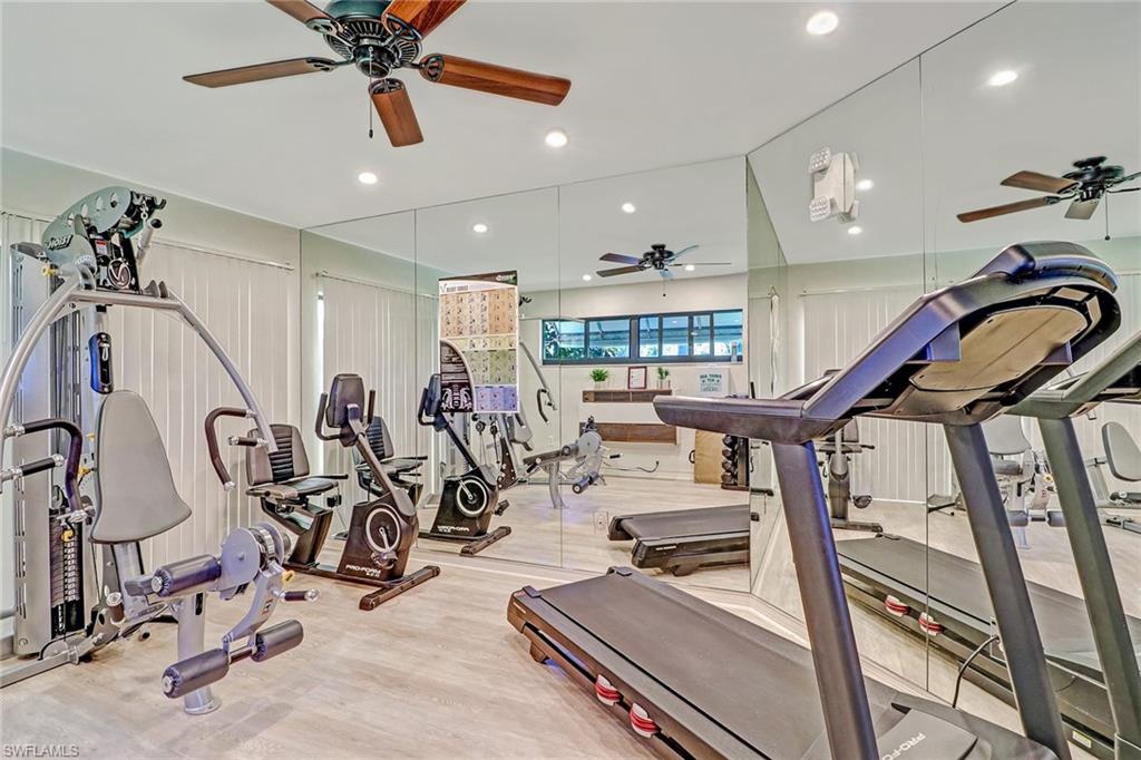716 Reef Point Circle Naples, FL 34108 - Photo 14 of 15 a view of a room with gym equipment