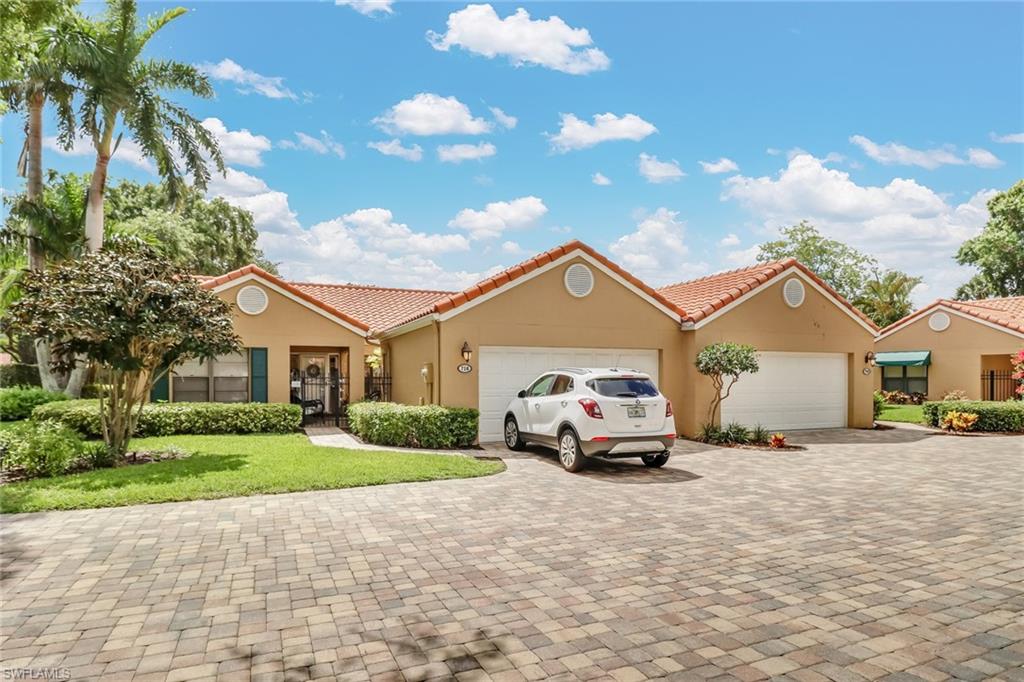716 Reef Point Circle Naples, FL 34108 - Photo 2 of 15 a car parked in front of a house with a yard