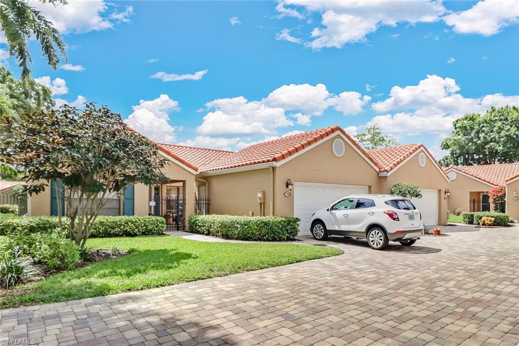 716 Reef Point Circle Naples, FL 34108 - Photo 5 of 15 a car parked in front of a house