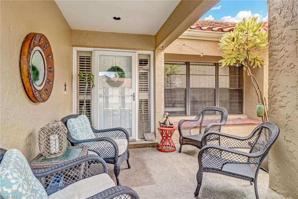 716 Reef Point Circle Naples, FL 34108 - Photo 6 of 15 a living room with furniture and a large window
