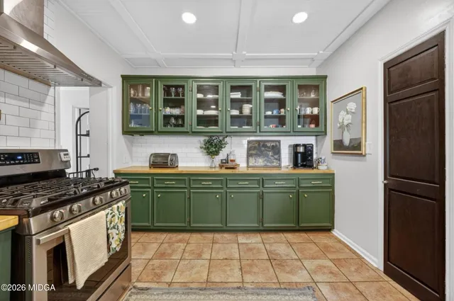 a kitchen with a refrigerator a stove and a sink
