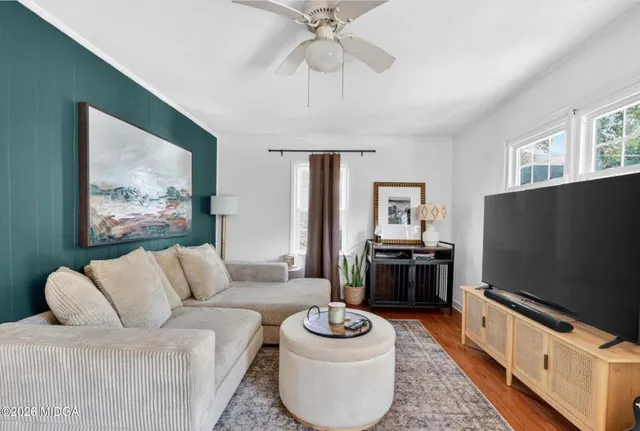 a living room with furniture and a flat screen tv