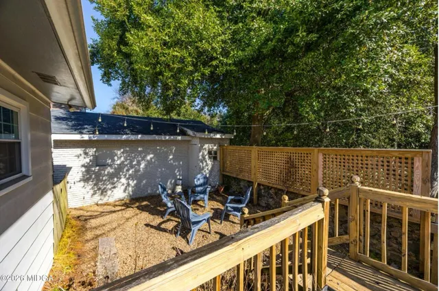 a view of a patio with table and chairs and wooden floor