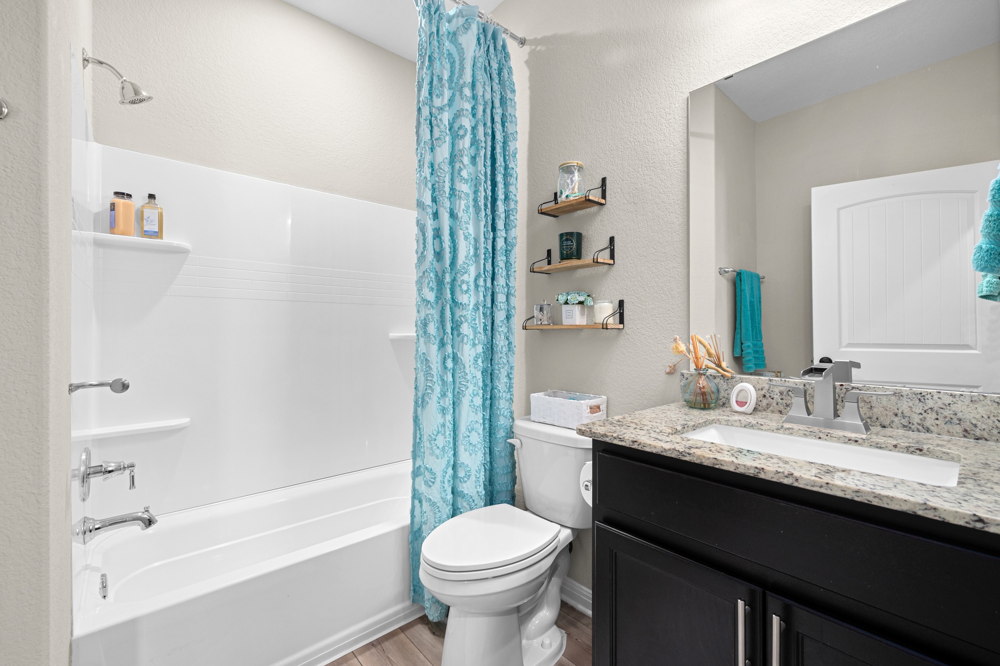 202 Yorktown Street Georgetown, TX 78633 - Photo 16 of 35 Bright and airy, the secondary full bathroom offers a functional tub and shower combination and generous space to move around