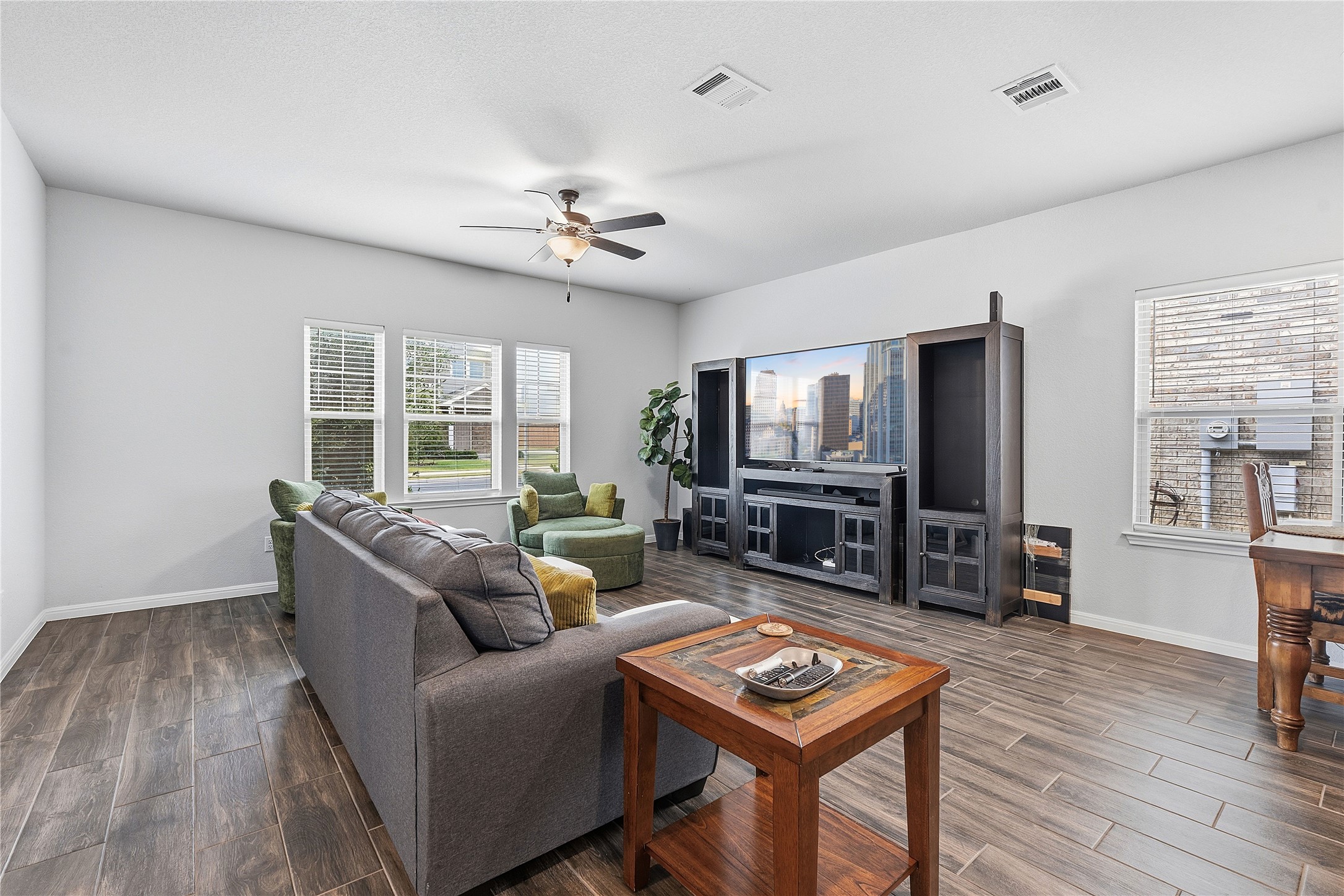 140 Pentro Path Georgetown, TX 78626 - Photo 11 of 33 A well-lit living space features durable flooring and multiple windows for abundant natural light.