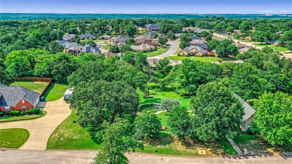 an aerial view of residential house with outdoor space and trees all around