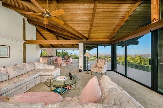 a view of a living room with furniture and entryway